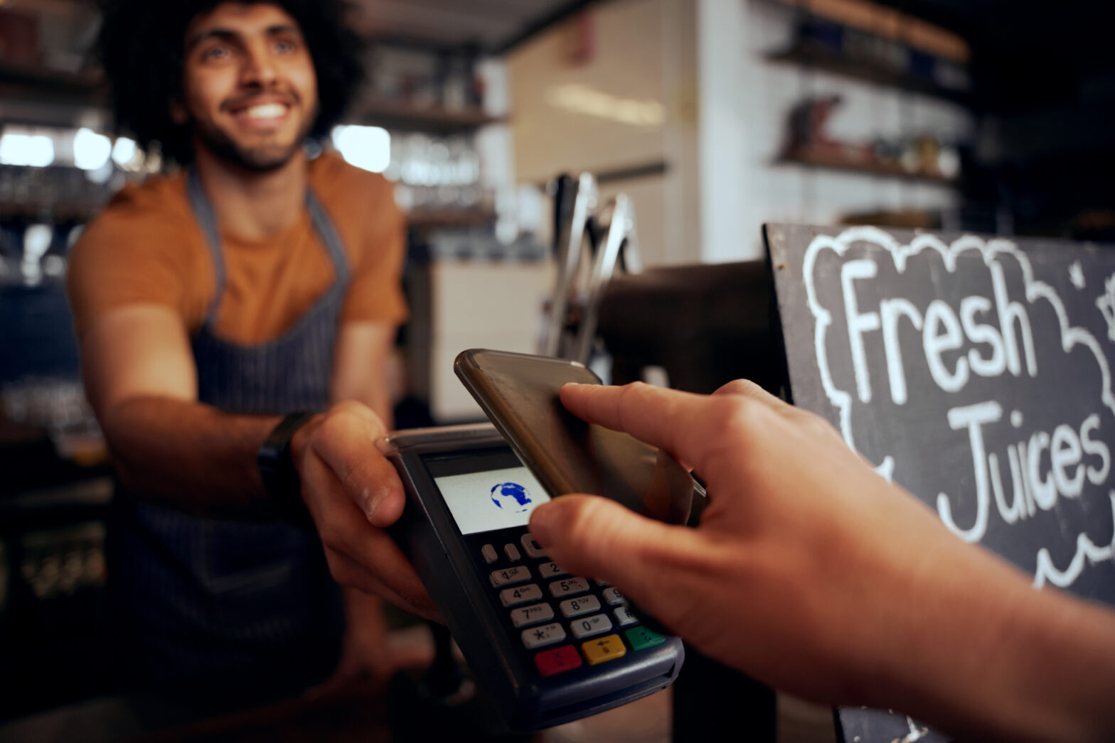 Busy café with card payment machine in use